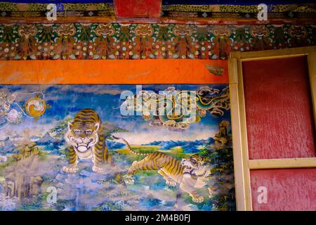 Tigers painted on a Buddhist wall painting inside the Palcho monastery. Gyantse. Tibet Autonomous Region. China. Stock Photo