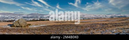 This panorama image is of the Yorkshire Dales Three Peaks as seen from the ice age relic the Big Stone on Burnmoor above the town of High Bentham Stock Photo
