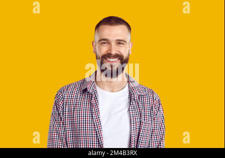 Elderly happy mustache bearded man 40s in plade shirt isolated on plain pastel light yellow background studio. People lifestyle concept Stock Photo