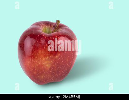 juicy red delicious apple on a light blue background. Front view and copy space. Stock Photo