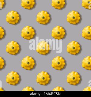 Seamless pattern with yellow bush pumpkin on a gray background. Top view image Stock Photo