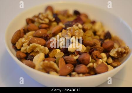 Nuts in a white plate. White background. Hazel nuts. Cashew nuts. Quality nuts. Nutty nuts. Nuts on nuts. Nuts everywhere :) Stock picture. Stock Photo