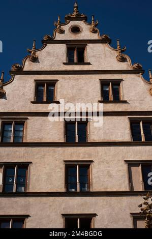 Elegant scrolled gable with curvilinear slopes decorated with obelisks and fins of Maison Kern, built 1594 in Rhenish or German Renaissance style at Rue du Conseil-Souverain 1 in the historic heart of Colmar, Alsace, Grand Est, France. Stock Photo