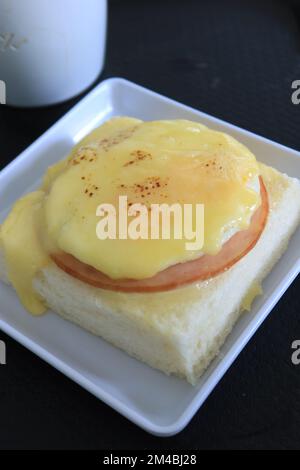 cured ham, egg and bread and cup of tea on table  Stock Photo