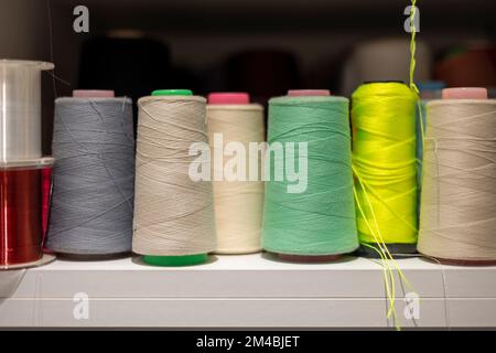 Many colors of thread on the shelves Stock Photo - Alamy