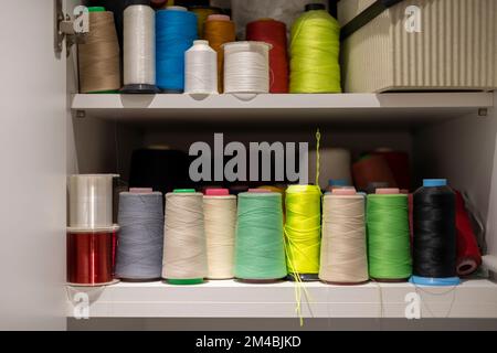 Many colors of thread on the shelves Stock Photo