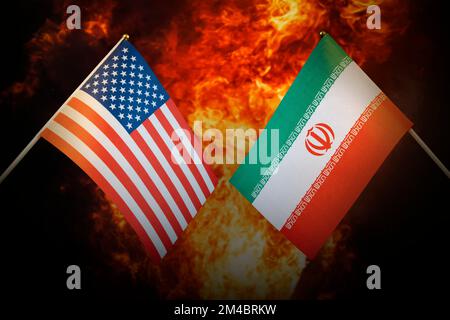 Flags of iran and United States of america against the background of a fiery explosion. The concept of enmity and war between countries. Tense politic Stock Photo