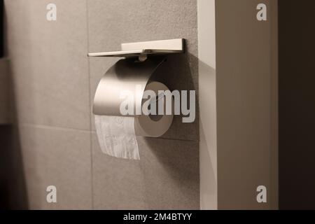 Toilet paper holder with a toilet paper Stock Photo