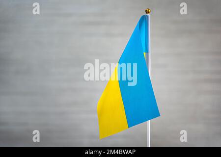 Ukraine's flag is on a white background. flag symbols of Ukraine. close up of a Ukrainian flag waving in the wind. Stock Photo