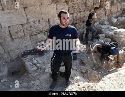 An archeologist from The Israel Antiquities Authority holds clay lamps from the eighth and ninth centuries CE, unearthed in the courtyard of an elaborate 2,000 year old Second Temple Period family burial cave, known as the Salome Cave, in the Lachish Forest in the Judean lowlands, on Tuesday, December 20, 2022. Archeologists say the cave was continued to be used in the Byzantine and Early Islamic Periods and became known as the Salome Cave due to the tradition that believes it is the burial place of Salome, the midwife of Jesus. Photo by Debbie Hill/ UPI