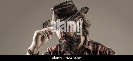 Portrait of young man wearing cowboy hat. Cowboys in hat. Handsome bearded macho Stock Photo