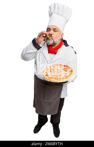 Portrait of bearded man, restaurant chef in uniform serving delicious pizza isolated on white background. Perfect Italian taste Stock Photo