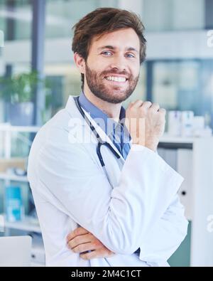 Portrait, man and doctor in hospital, smile and confident at work, wellness or healthcare for community. Male, medical professional or surgeon ready Stock Photo