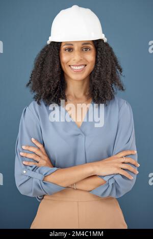 Black woman, portrait and hard hat for architecture, engineering and construction safety on studio background in Brazil. Happy female contractor Stock Photo