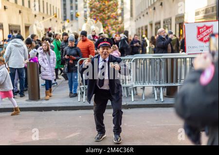 Energetic Salvation Army worker on a car-free Fifth Avenue in Midtown Manhattan during the last Holiday Open Streets of the season on Sunday, December 18, 2022. New York City closed a nine-block stretch of Fifth Avenue in Midtown to vehicles for four Sundays in December creating a holiday block party for visitors. (© Richard B. Levine) Stock Photo