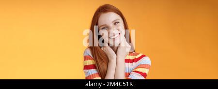 Silly enthusiastic attractive redhead blue-eyed girl tilting head touching neck flirty smiling enjoy perfect day feel happiness joy giggling Stock Photo