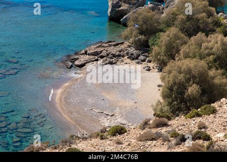 Mediterranean Sea on the rocky coast. Deserted beach called three crosses with clear turquoise water. Located near Stegna, Archangelos, Rhodes, Greece. Stock Photo