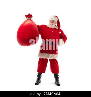 Santa Claus shows Christmas gift bag isolated on white background Stock Photo