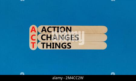 ACT action changes things symbol. Concept words ACT action changes things on wooden sticks on a beautiful blue table blue background. Business and ACT Stock Photo
