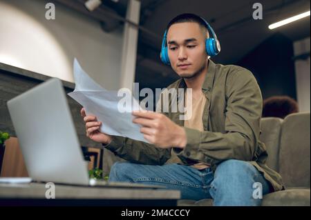 Young company employee focused on reading documentation Stock Photo