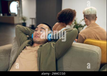 Company employee resting in the lounge area Stock Photo