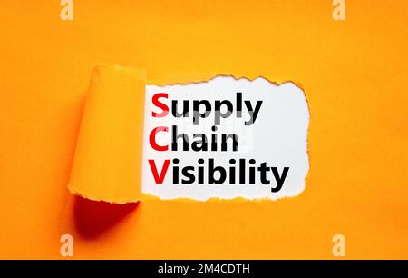 SCV supply chain visibility symbol. Concept words SCV supply chain visibility on white paper on a beautiful orange background. Business SCV supply cha Stock Photo