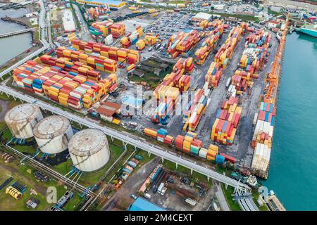 Containers in cargo freight port, aerial view. Industrial harbor, global transportation and international logistic business concept. Stock Photo