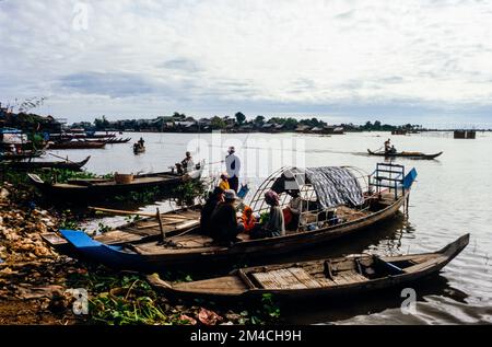 Boots are the way to carry goods across the Tonle Sap River Stock Photo