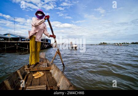 Boots are the way to carry goods across the Tonle Sap River Stock Photo