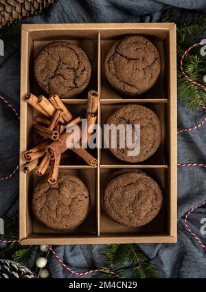 Gift box of molasses cookies with cinnamon sticks Stock Photo