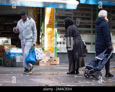 A homeless beggar, begging for cash in Walthamstow market, London, UK, the longest outdoor market in Europe, Stock Photo