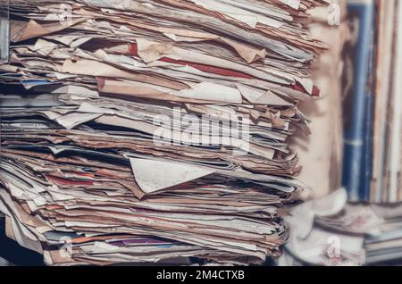 Documents, old papers in folders on shelves are stacked in a mess Stock Photo