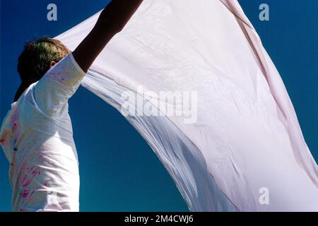 Pilgrim drying his cloths after having a bath in the river Yamuna Stock Photo