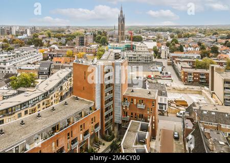 a city from the top of a tall building with a clock tower in the distance and buildings on both sides Stock Photo