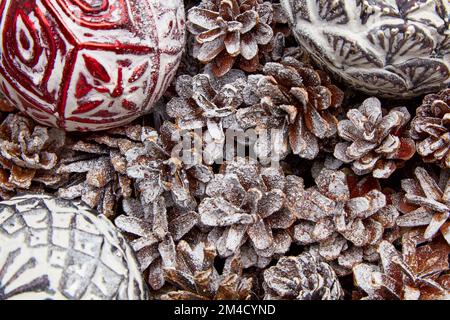 Pine and fir cones and Christmas tree glass balls toys covered with snow and frost Stock Photo