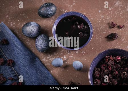Process of dyeing eggs with natural paints for Easter. Stock Photo