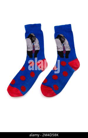 Funy blue socks with monkeys and red dots on them isolated on a white background Stock Photo