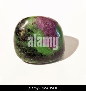 Macro close up colour photograph of 'Ruby in Zoisite' a semi precious crystal gemstone used in crystal healing therapy Stock Photo
