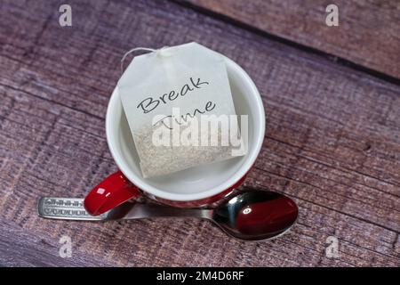 Cup and tea bag labeled 'Break Time' Stock Photo
