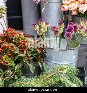 A variety of colors near the Liberty store in London. Large bouquets in tin vases. Stock Photo