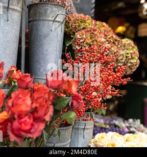 A variety of colors near the Liberty store in London. Large bouquets in tin vases. Stock Photo