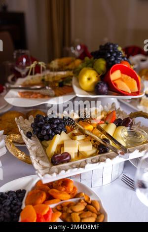 cheese slicing on the table and various snacks on the table Stock Photo