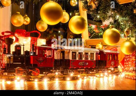 Berlin, Germany - December 16, 2022: Christmas train amid twinkling lights and Christmas decorations. Stock Photo