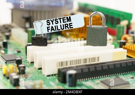 Computer security concept. There is a sticker on the motherboard that says - System Failure Stock Photo