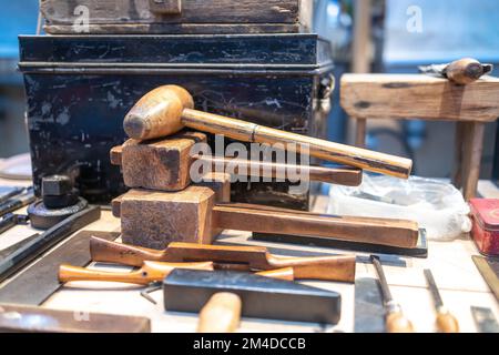 Wooden hammers, screwdrivers and various carpentry tools on the counter at Spitalfields Flea Market Stock Photo