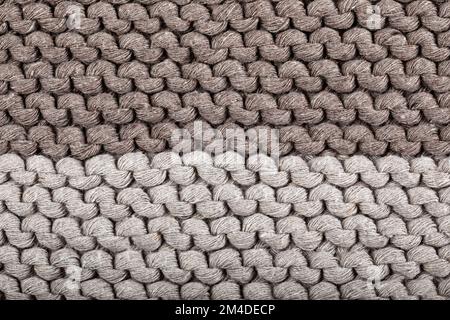 Detail of the handmade knitted pattern (two different shades of brown). Backgrounds. Texture. Stock Photo
