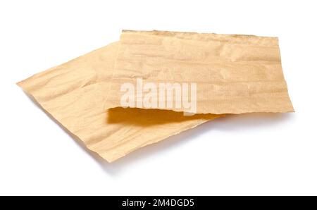Baking paper isolated. Crumpled pieces of brown parchment or baking paper on white background. Design element. Stock Photo