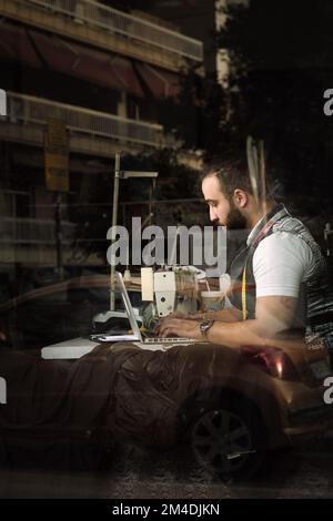 Man sewing Stock Photo