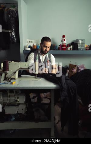 Man sewing Stock Photo