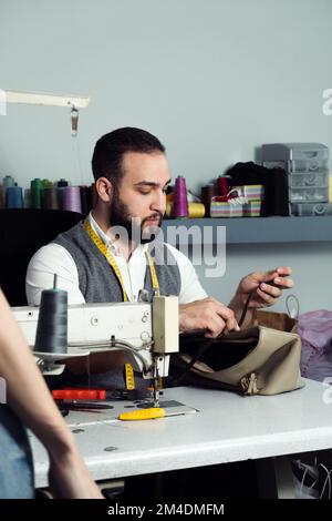 Man sewing Stock Photo